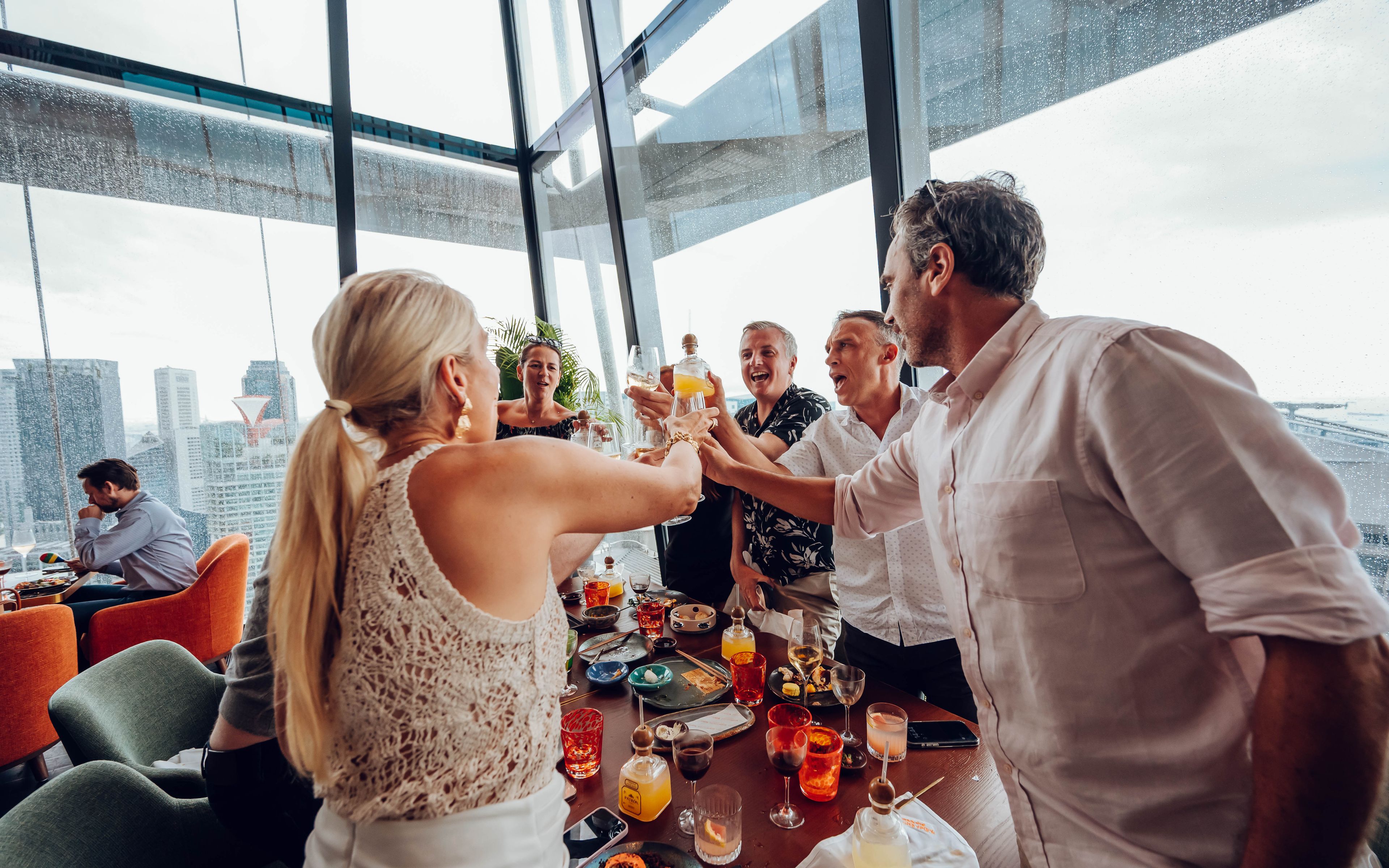 SUSHISAMBA Race to Samba Brunch guests clinking glasses at table