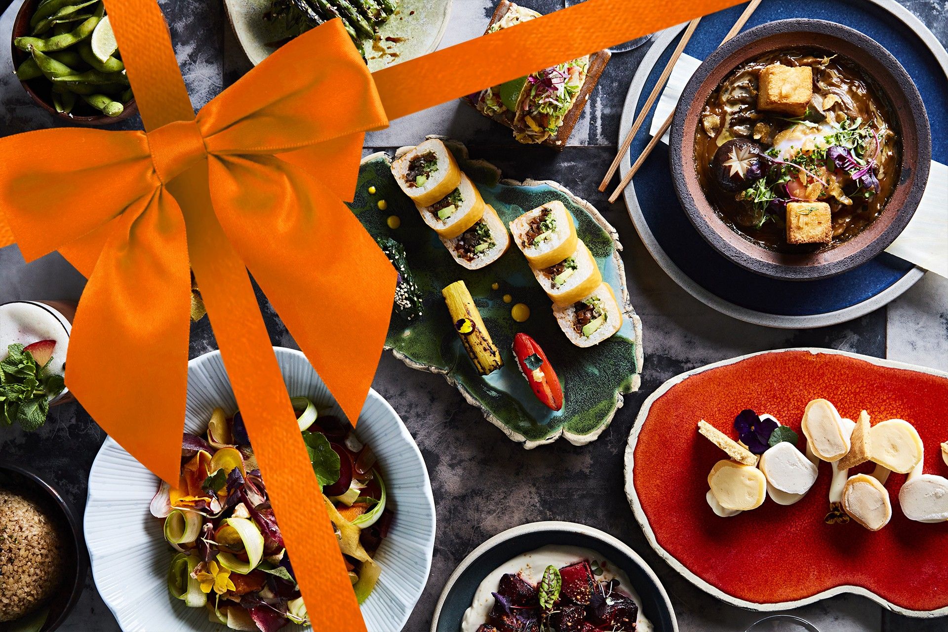 image of sushisamba dishes with a orange gift bow overlay